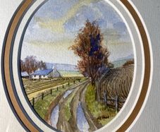 picture Country lane landscape featuring a whitewashed cottage, bare trees, and rutted track.