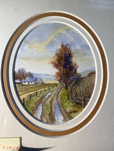 picture Country lane landscape featuring a whitewashed cottage, bare trees, and rutted track.