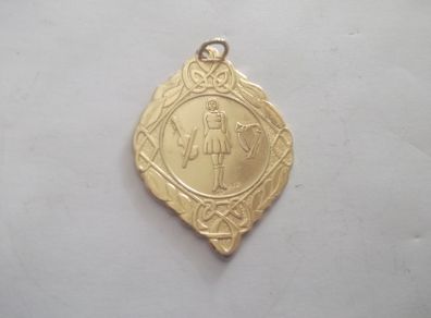 a gold plated irish dance medal