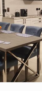 Grey dining table with chrome X legs