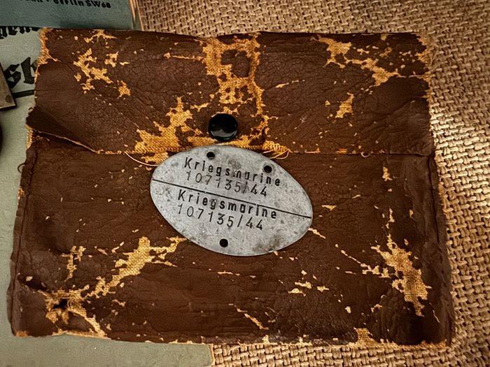 WW2 German documents with an eagle pin and an identification tag for one soldier