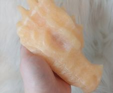 Large orange calcite dragon head carving