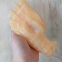 Large orange calcite dragon head carving