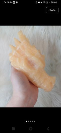 Large orange calcite dragon head carving