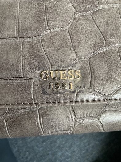 Guess purse. Never used. Slightly worn on inside due to storage.