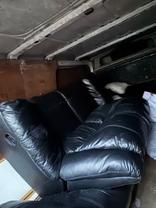 Black leather recliner sofa