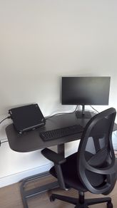 Standing desk with an office chair and desk lamp