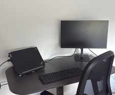 Standing desk with an office chair and desk lamp