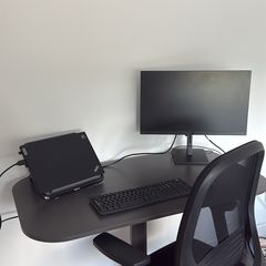 Standing desk with an office chair and desk lamp
