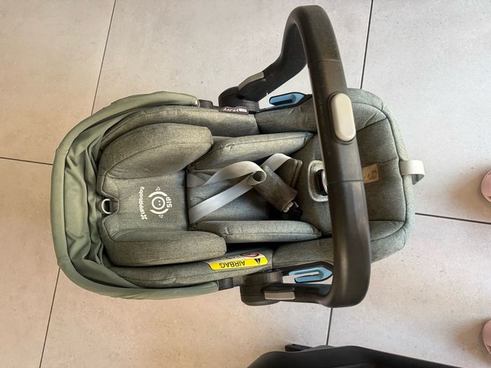 This is an UPPAbaby Mesa i-Size Infant Car Seat in a green-toned fabric.