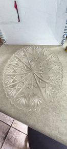 Clear cut-glass or crystal flat cake plate or serving platter featuring a radial starburst and fan-cut pattern