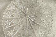 Clear cut-glass or crystal flat cake plate or serving platter featuring a radial starburst and fan-cut pattern