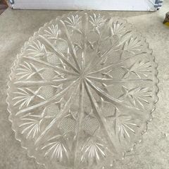 Clear cut-glass or crystal flat cake plate or serving platter featuring a radial starburst and fan-cut pattern