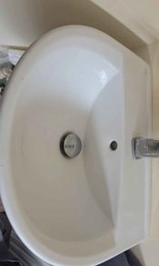2 White pedestal sink and small radiator