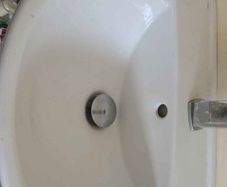 2 White pedestal sink and small radiator