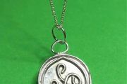 Sterling silver Triskele pendant with 18 inch chain.
