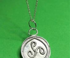 Sterling silver Triskele pendant with 18 inch chain.