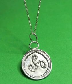 Sterling silver Triskele pendant with 18 inch chain.