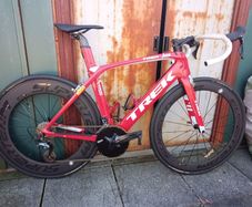 Trek Madone SL6 rim brake in vibrant red (not incl. wheels in pic).