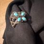 silver tone butterfly cuff bracelet featuring faux turquoise stones and intricate wire work. Image 2