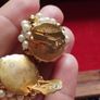 Vintage clip-on earrings with a cluster of faux pearls and gold-tone beads. Image 4