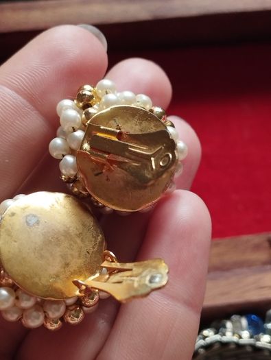 Vintage clip-on earrings with a cluster of faux pearls and gold-tone beads.