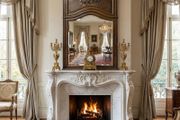 Fabulous antique carved wood mirror as an overmantel in this image