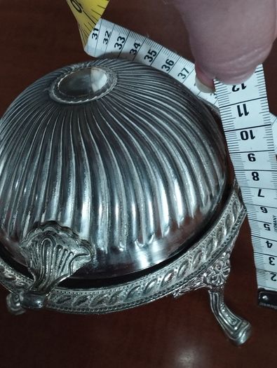 A vintage silver-plated butter dish or caviar bowl with a three-legged lid.