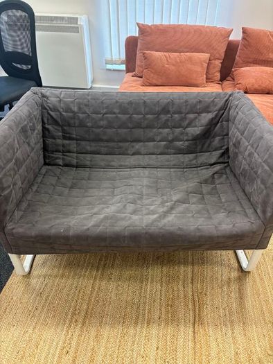 Grey quilted sofa with white metal frame