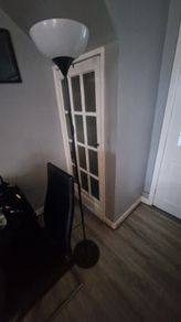 Black floor lamp with white uplighter shade
