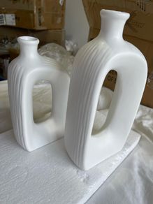 Brand new modern, hollow-center white ceramic/porcelain decorative donut-shaped vases.