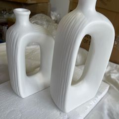 Brand new modern, hollow-center white ceramic/porcelain decorative donut-shaped vases.
