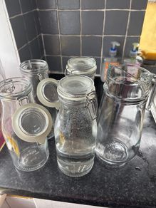 4 Ikea bottle shaped jars and 1 jug