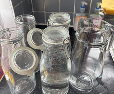 4 Ikea bottle shaped jars and 1 jug
