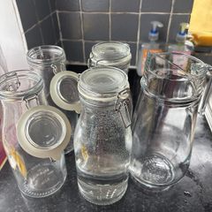 4 Ikea bottle shaped jars and 1 jug