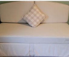 Sofa bed, single bed sized when cushions are removed.