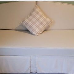 Sofa bed, single bed sized when cushions are removed.