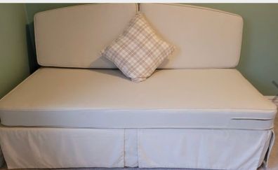 Sofa bed, single bed sized when cushions are removed.