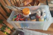 box of acrylic paints and brushes