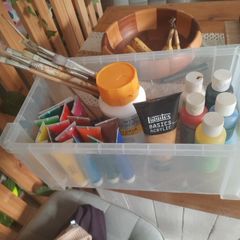 box of acrylic paints and brushes