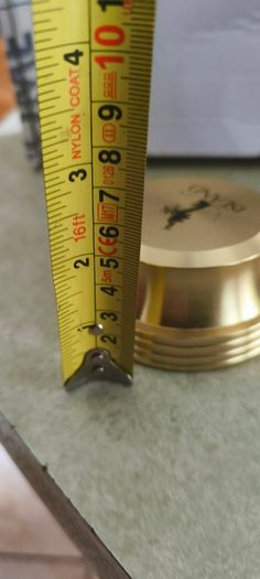 2 Papper Weight , Brass Papper Weight marked ISLAND 12.00 euro. Cleare Risen Tile Papper Weight.with black velvet on the back.10.00 euro.