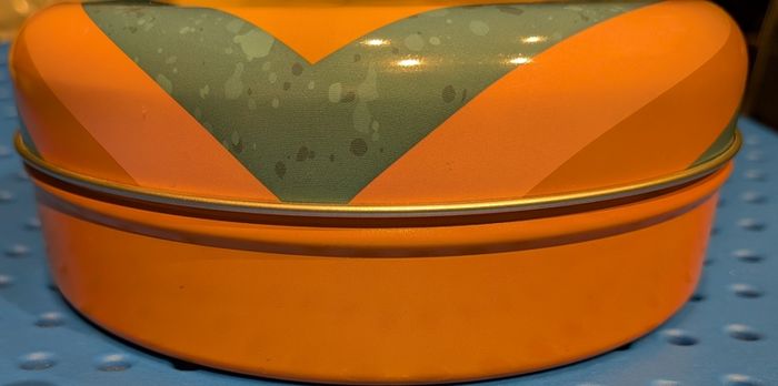 Colourful circular tin box