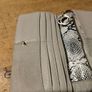 River Island clutch purse featuring a dual-texture gray flap panel design and a central dark metallic logo plate. Perfect inside. Image 10