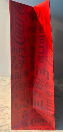 House of Coca-Cola Paper Gift Bag featuring white rope handles