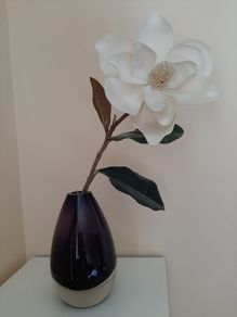 Purple bullet glass vase with cream single flower