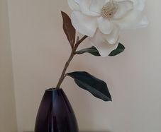 Purple bullet glass vase with cream single flower