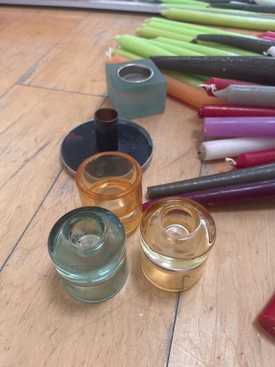 Large collection of  coloured candles and candle holders a few broken and few slightly used