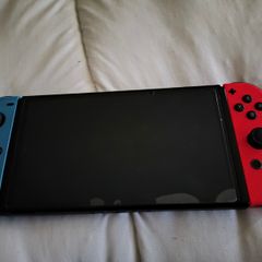 Nintendo Switch OLED console for sale + 2 Joy-Con controllers.