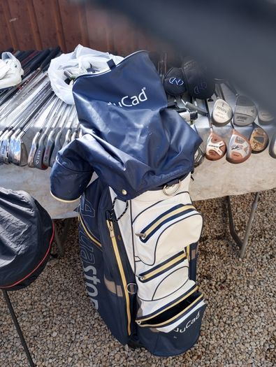 A selection of golf clubs and bags. All right handed clubs.