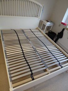 White wooden bed frame with slatted base